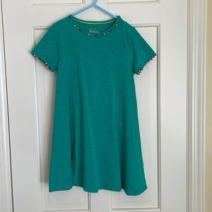 Emerald green T shirt dress with colored fabric balls at neck and arm